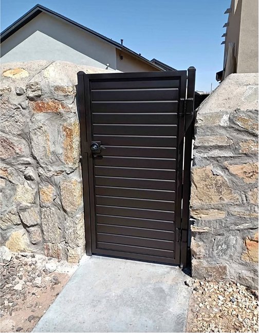 Modern metal gate and rock wall in El Paso Texas